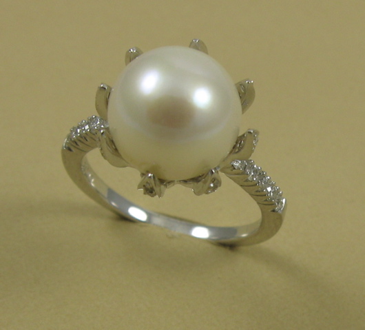 Appraisal: PEARL DIAMOND AND FOURTEEN KARAT GOLD RING centering a round