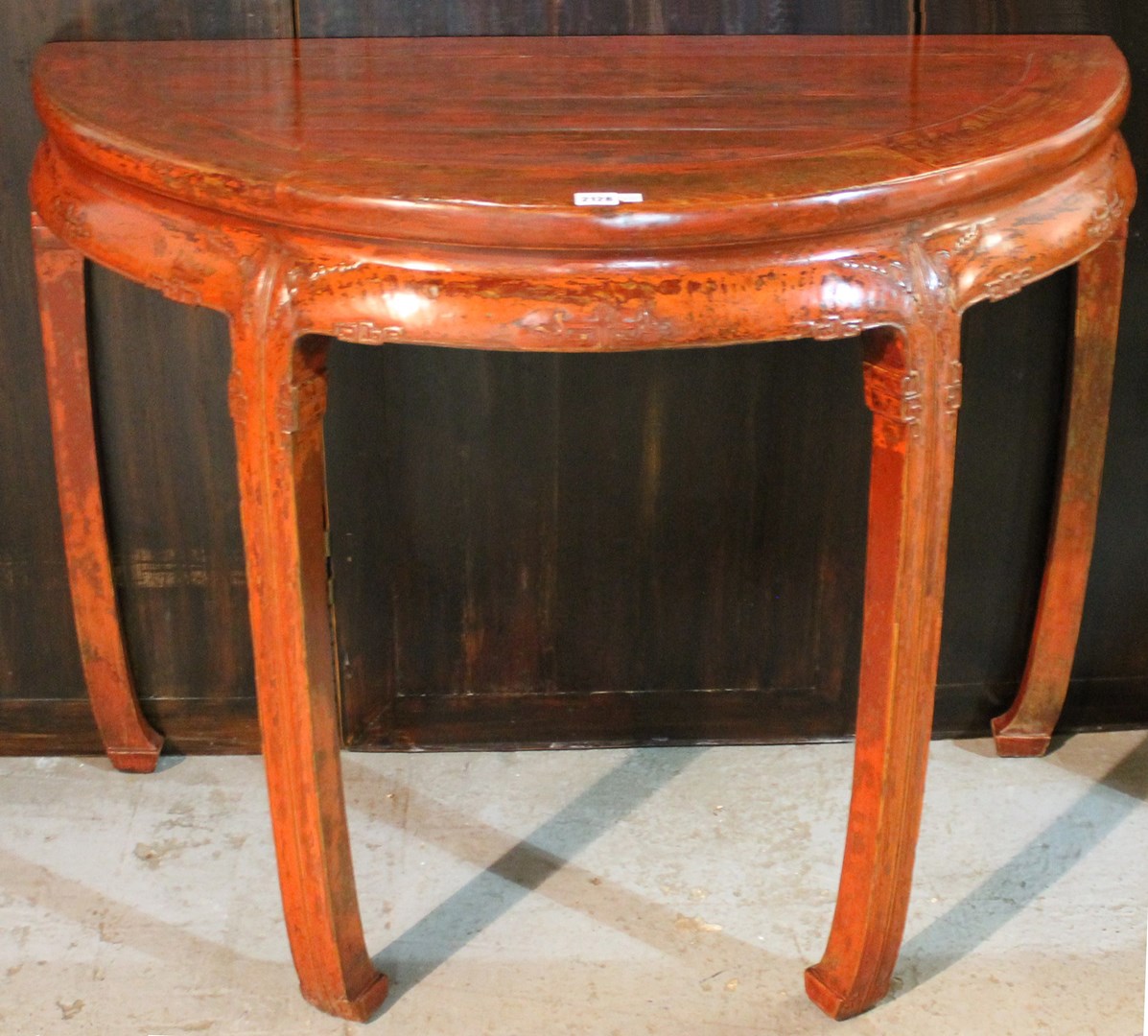 Appraisal: A late th century Chinese red lacquer semi elliptic console