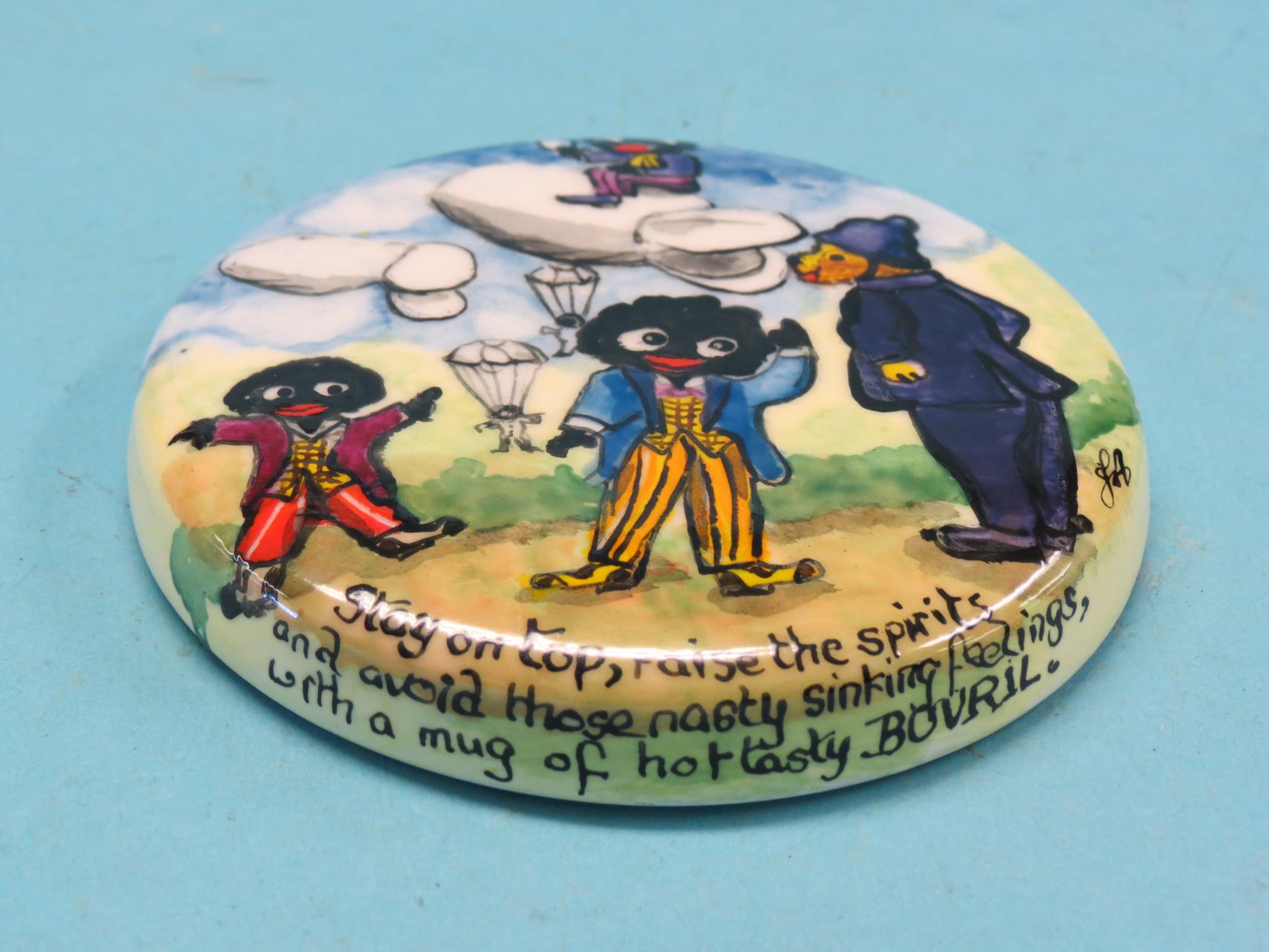 Appraisal: A ceramic pot-lid comical gollys advertising Bovril by Joan Allen