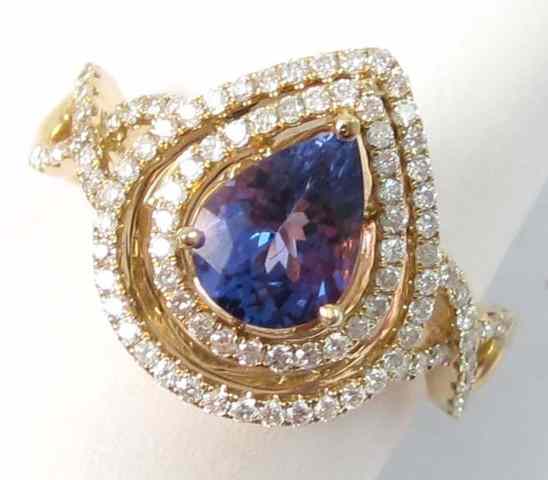 Appraisal: TANZANITE DIAMOND AND FOURTEEN KARAT GOLD RING centering a pear-cut