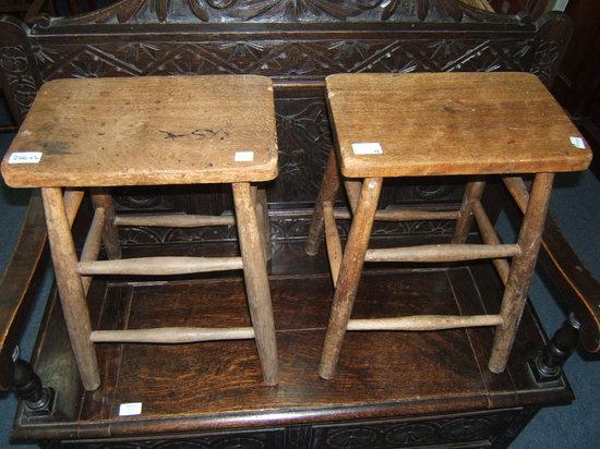 Appraisal: A pair of elm stools on turned legs united by