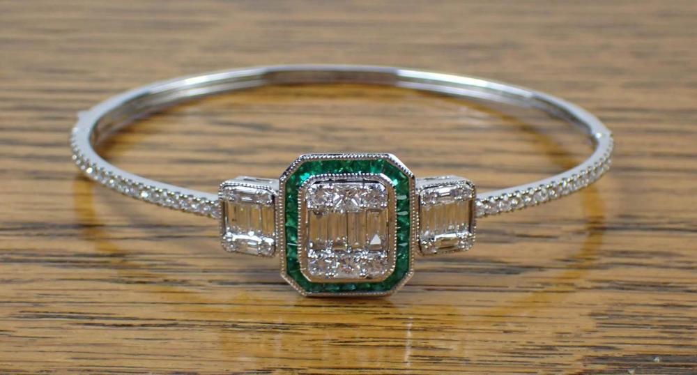 Appraisal: DIAMOND EMERALD AND EIGHTEEN KARAT GOLD BANGLE The k white