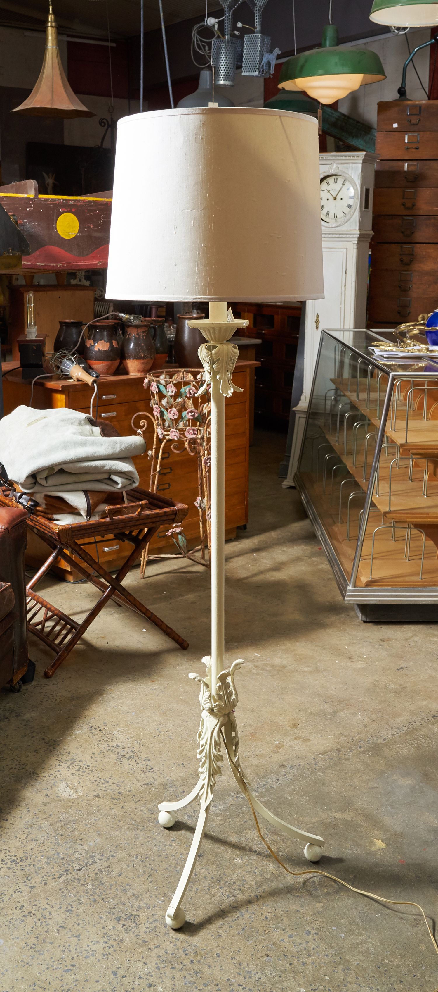 Appraisal: A HOLYWOOD REGENCY INSPIRED STANDARD LAMP Cast iron on tripod