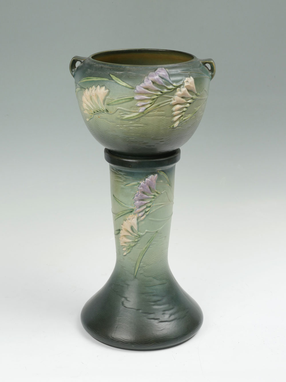 Appraisal: ROSEVILLE POTTERY FREESIA JARDINIERE AND PEDESTAL Roseville Pottery handled Jardiniere