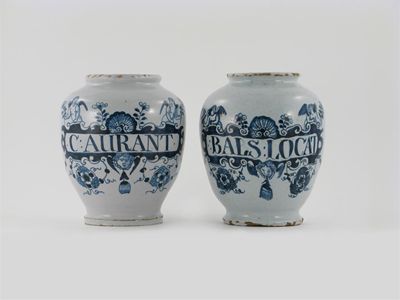 Appraisal: A matched pair of delftware dry drug jars painted with