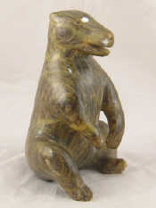 Appraisal: A carved stone figure of a seated bear signed to