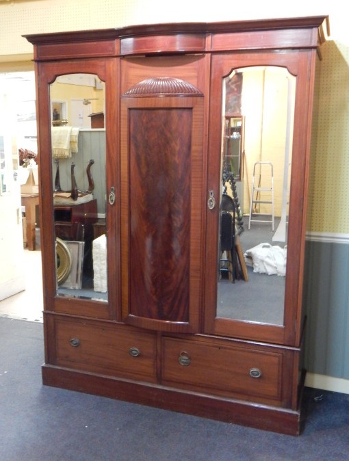 Appraisal: An Edwardian mahogany and tulip wood banded triple wardrobe with