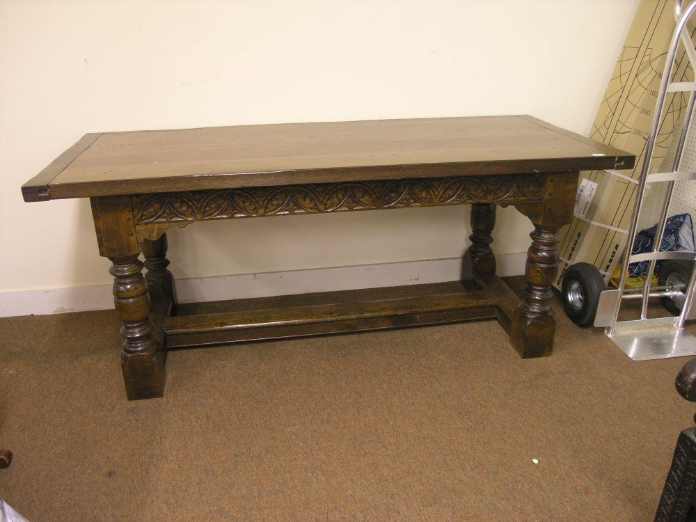 Appraisal: A solid dark oak refectory dining table with carved frieze