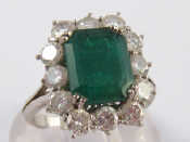 Appraisal: A white metal tests carat gold emerald and diamond ring