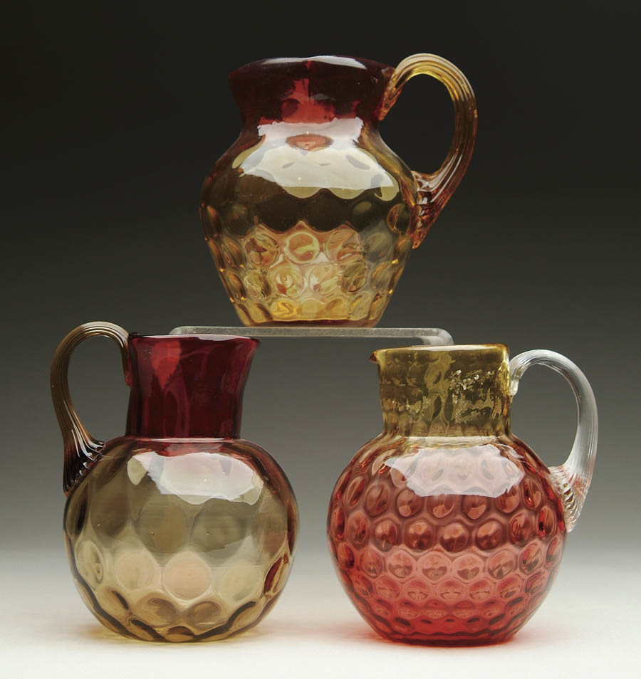 Appraisal: THREE AMBERINA PITCHERS Inverted thumbprint Amberina pitcher has applied reeded