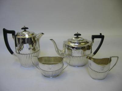 Appraisal: AN EDWARDIAN TEAPOT AND CREAM JUG maker H A Sheffield