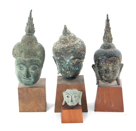 Appraisal: Asian bronze Buddha heads on pedestals probably Thai th century