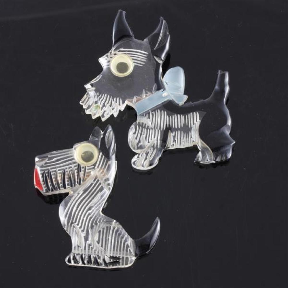 Appraisal: TWO GOOGLY EYED REVERSE CARVED AND PAINTED DOG SCHNAUZER PINS