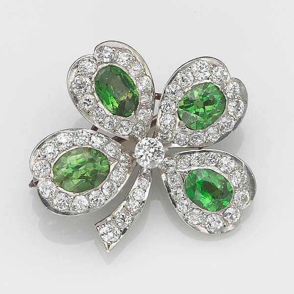 Appraisal: A demantoid garnet diamond and platinum-topped k gold four leaf