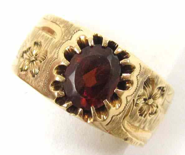 Appraisal: GARNET AND FOURTEEN KARAT GOLD RING yellow gold prongs secure