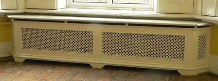 Appraisal: A double pierced cast radiator surround with marble top on