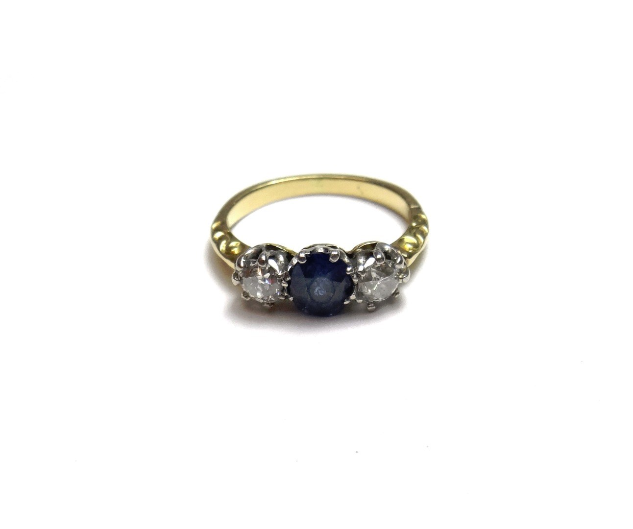 Appraisal: A gold sapphire and diamond set three stone ring claw