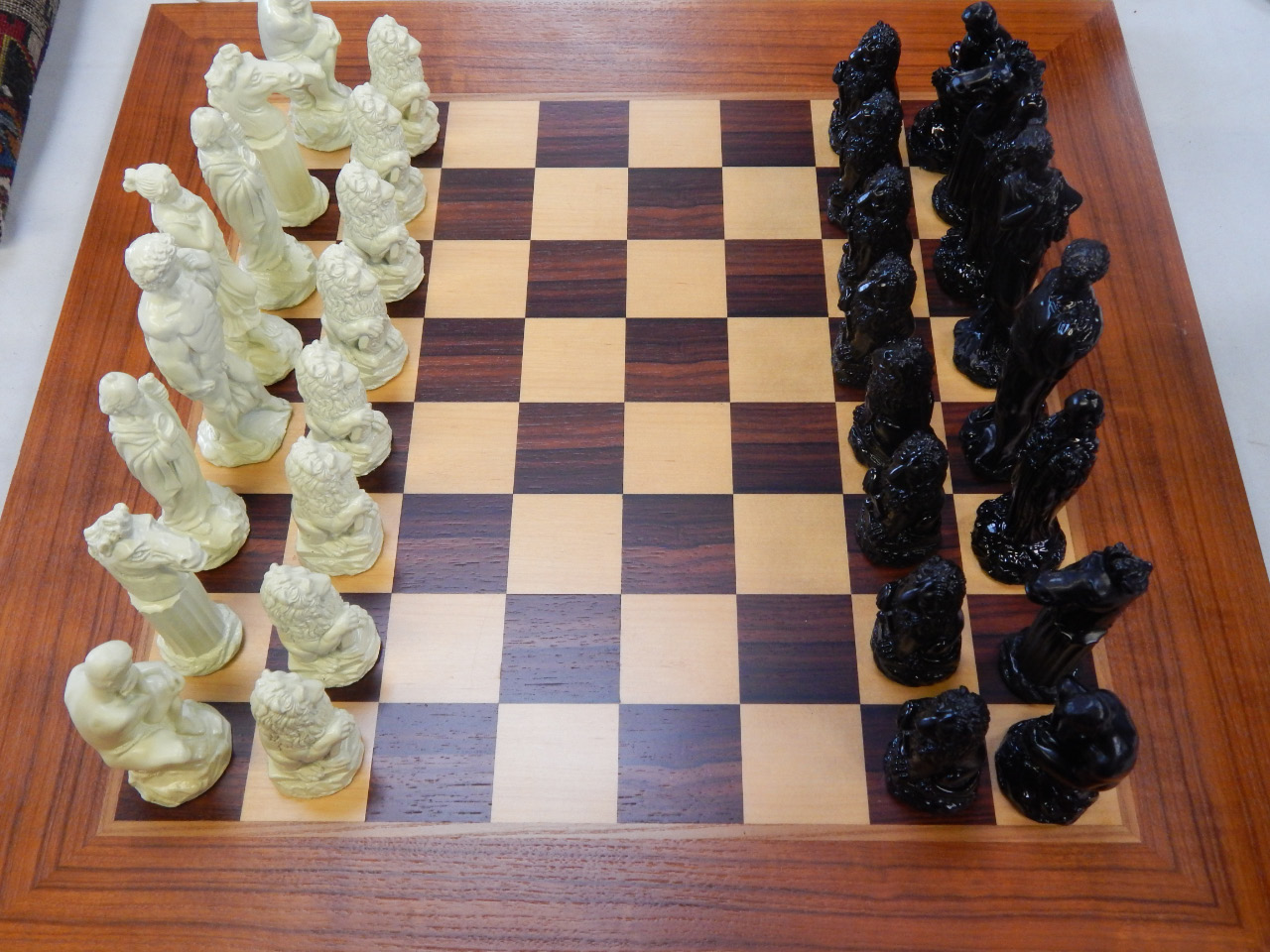 Appraisal: A hardwood inlaid chess and backgammon board and a resin