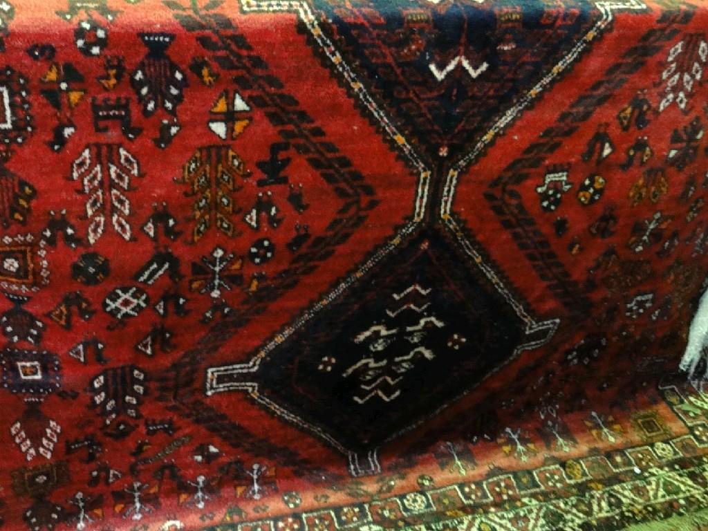 Appraisal: A Middle Eastern design carpet with three linked lozenge medallions