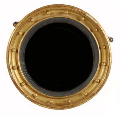 Appraisal: A circular giltwood and gesso convex mirror in Regency style