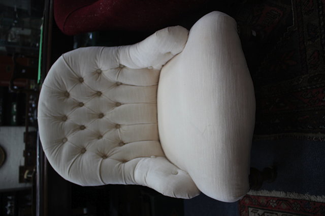 Appraisal: A VICTORIAN CREAM BUTTON UPHOLSTERED LOW OCCASIONAL CHAIR with turned