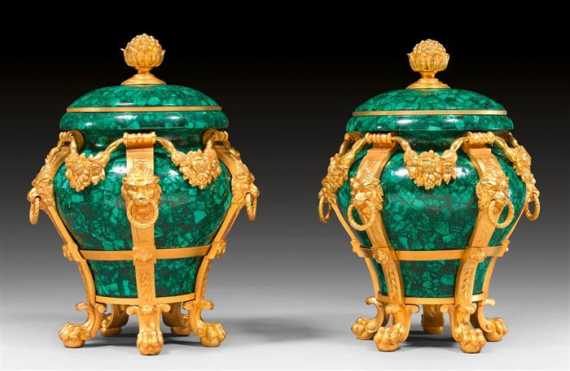 Appraisal: PAIR OF MALACHITE LIDDED CONTAINERS AUX TETES DE LIONS IN