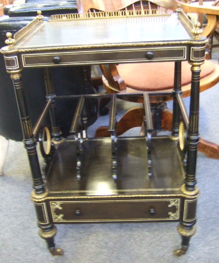 Appraisal: A Victorian ebonised and gilt metal mounted canterbury the galleried