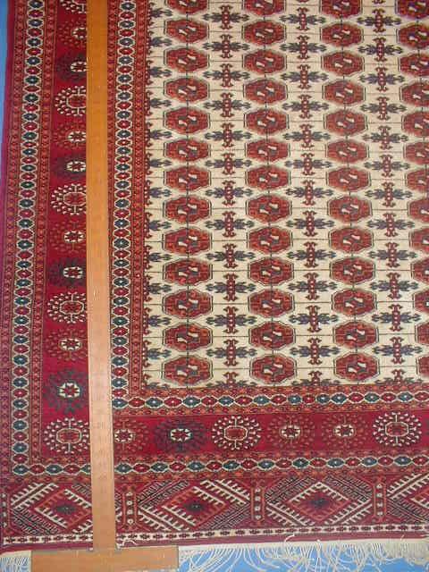 Appraisal: A Bokhara rug with red ground borders cream centre field