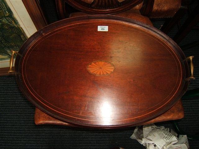 Appraisal: An Edwardian oval mahogany tray with satinwood inlay and brass