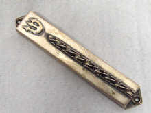 Appraisal: A silver mezuzah with scroll made in Israel