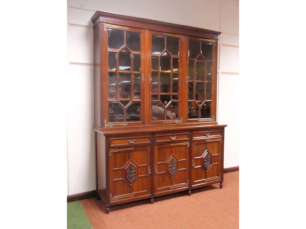 Appraisal: An early Edwardian mahogany bookcase by Maple Co Ltd the