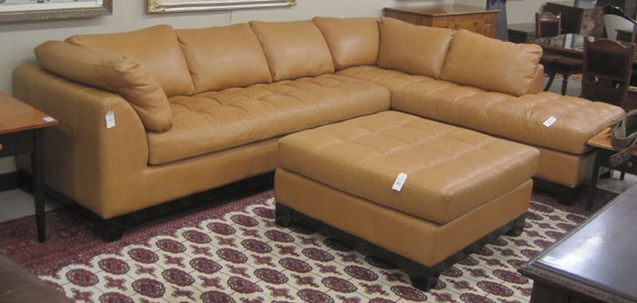 Appraisal: CONTEMPORARY THREE-PIECE LEATHER SECTIONAL SOFA AND OTTOMAN SET retailed by