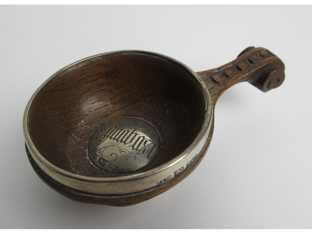 Appraisal: A Scottish oak quaich the centre inset in silver with