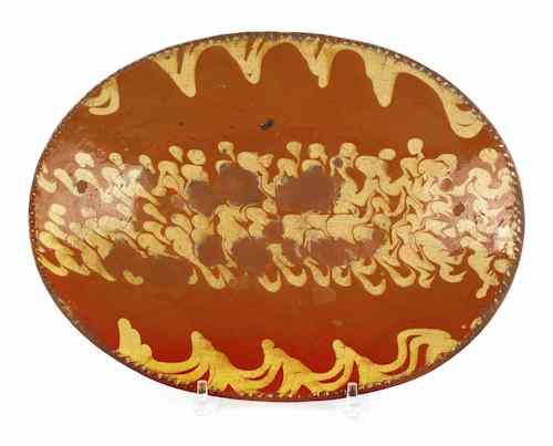 Appraisal: Pennsylvania slip decorated oval redware loaf dish with extensive yellow