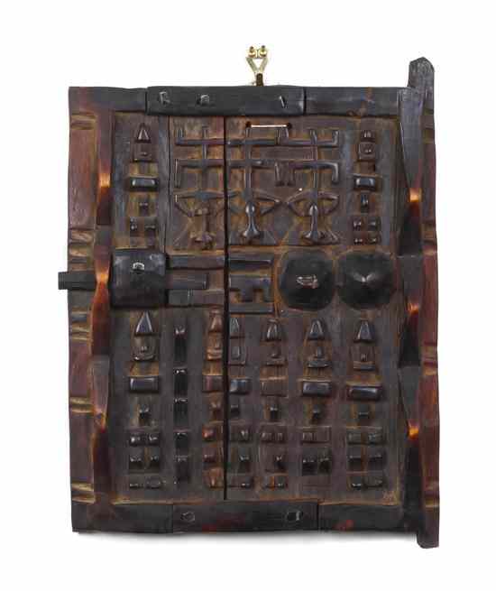 Appraisal: A Carved African Granary Door Dogon in low relief with