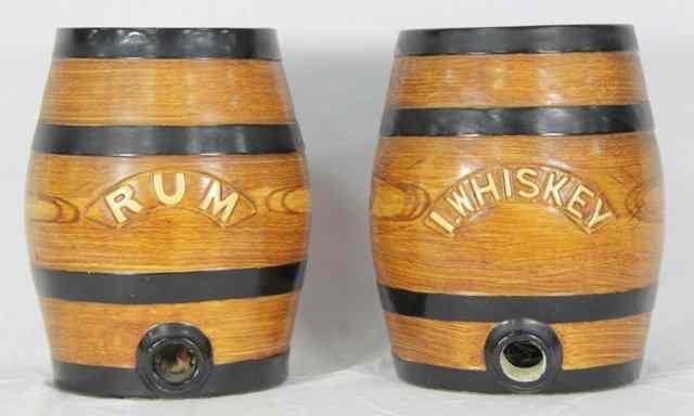 Appraisal: Two pottery spirit barrels Rum and Whisky painted to simulate