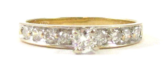 Appraisal: DIAMOND AND FOURTEEN KARAT GOLD RING with four round-cut diamonds