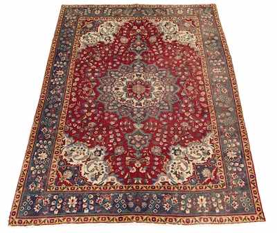 Appraisal: A Tabriz Carpet Flower form medallion in cranberry red ground