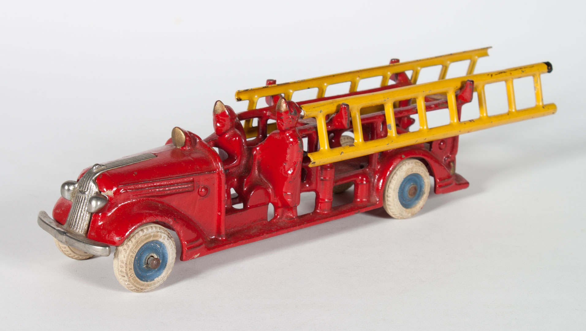 Appraisal: Arcade cast iron fire engine with pair stamped metal ladders