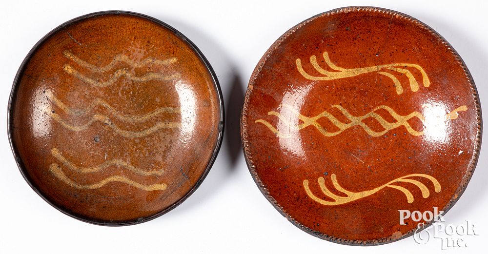 Appraisal: Two Pennsylvania redware plates th c Two Pennsylvania redware plates