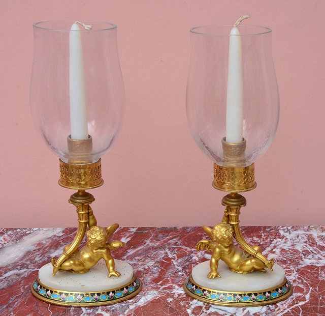 Appraisal: A PAIR OF GILT METAL AND CHAMPLEVE CANDLE HOLDERS each