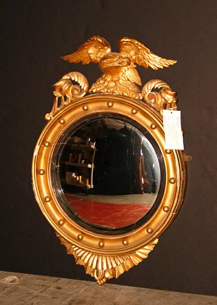 Appraisal: A Regency parcel gilt and ebonized convex mirror first quarter