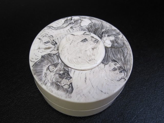 Appraisal: IVORY CARVED ROUND COVERED STORAGE BOX scrimshawed on cover with