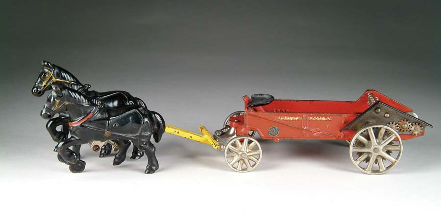 Appraisal: MCCORMICK-DEERING MANURE SPREADER W HORSES A red wagon embossed MCCORMICK-DEERING