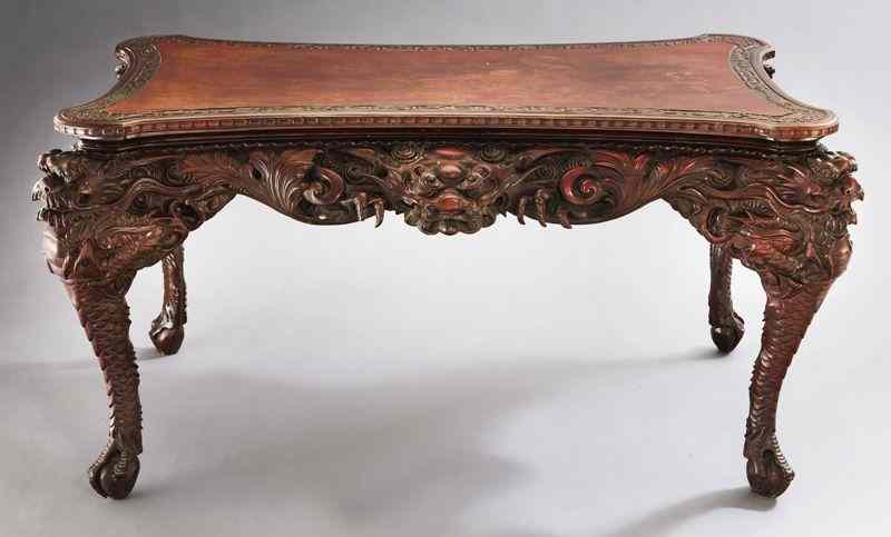 Appraisal: Japanese highly carved center tablehaving an incurved rectangular top with