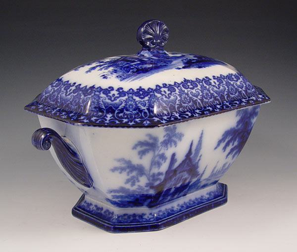 Appraisal: FLOW BLUE COVERED TUREEN Octagonal shape with scroll handles pedestal