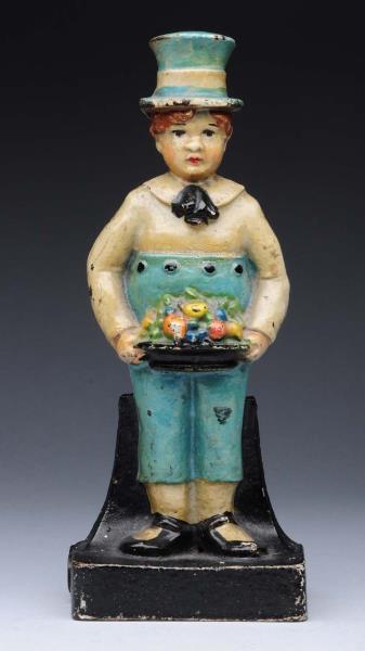 Appraisal: Cast Iron Boy Holding Fruit Doorstop Depicts young lad standing