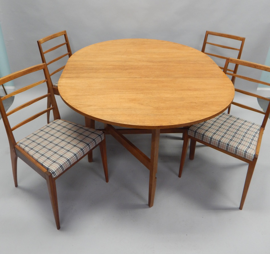 Appraisal: A retro style teak oval drop leaf table and four