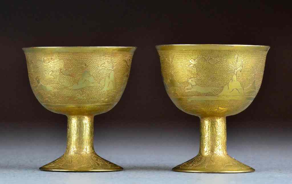 Appraisal: Pr Chinese Gilt Metal Wine CupsDepicting animal and floral design