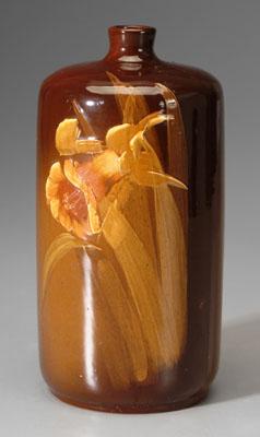 Appraisal: Owens pottery vase cylindrical bottle form brown glaze with daffodils